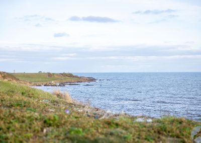 View of the sea beside a rugged coastline.